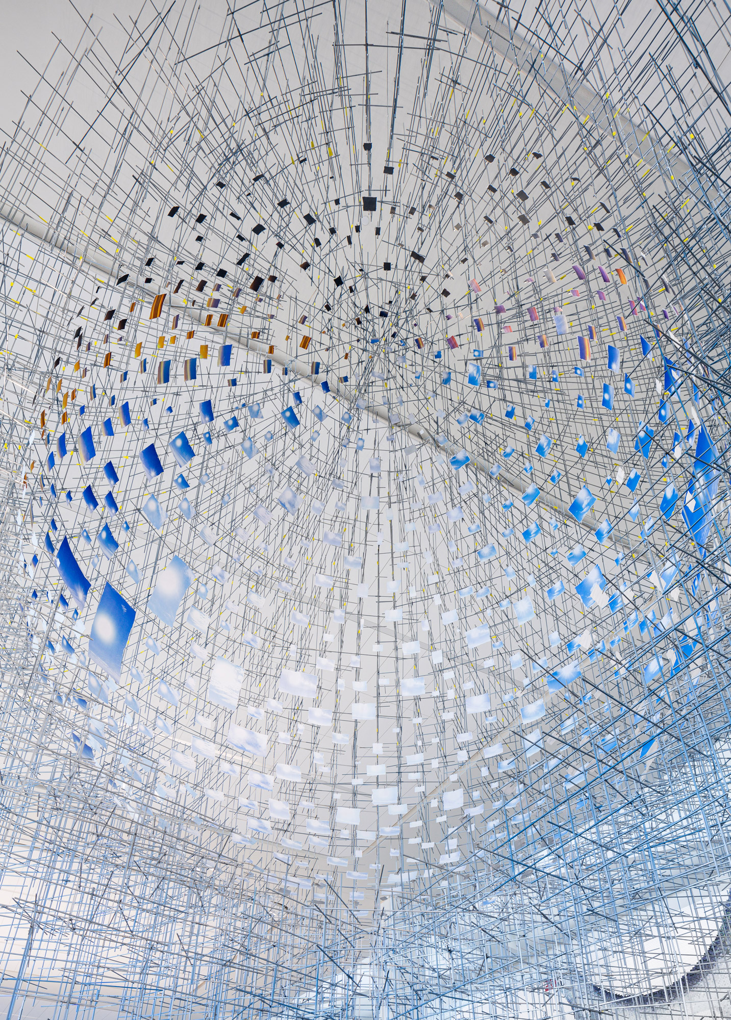 An intricate constellation of hundreds of photographs forming a mirage-like sphere that appears to float in midair.