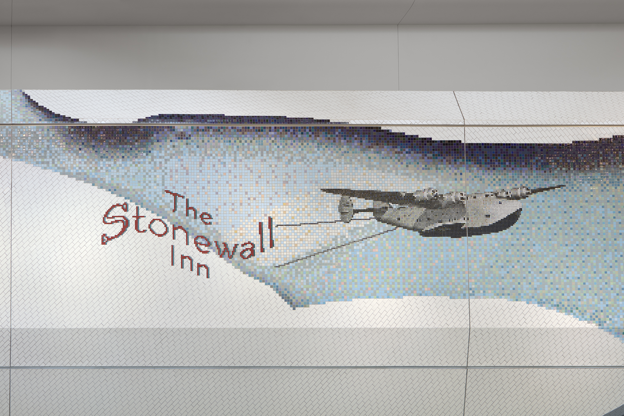 A tiled mosaic picturing the text The Stonewall Inn next to a jet plane flying through a light blue sky peaking through two large white cloud.