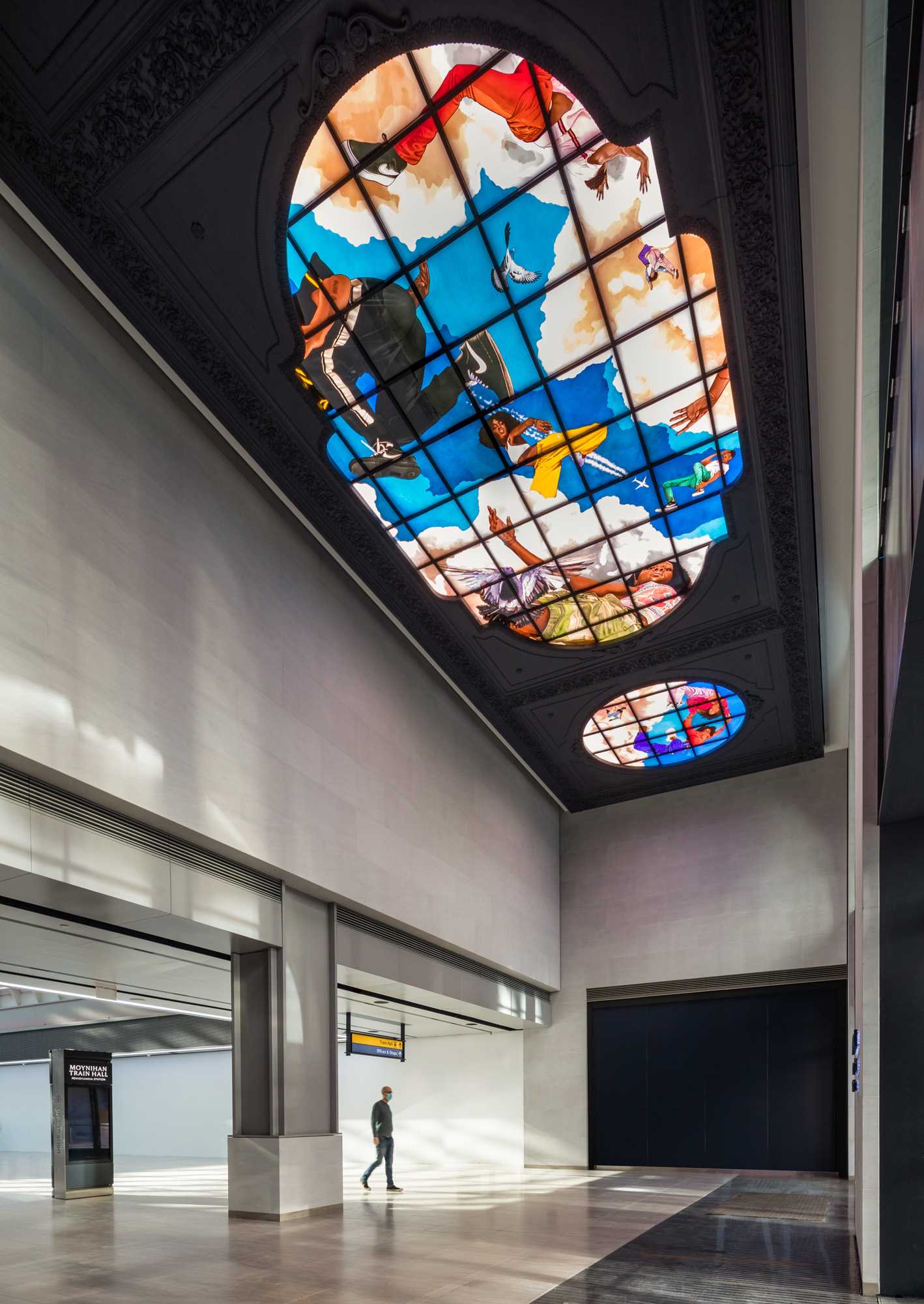 A brightly painted stained glass triptych depicting young Black people in poses drawn from breakdance, set against billowing clouds in a brilliant blue sky.