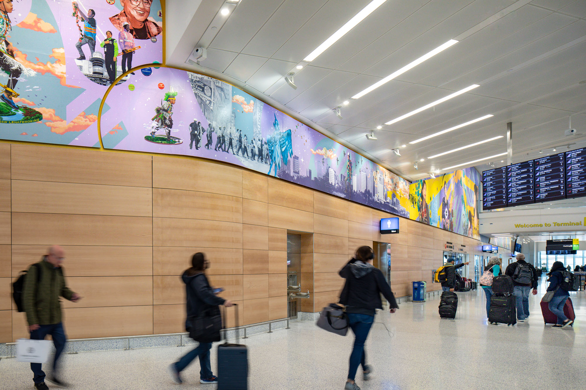 A brightly colored horizontal mural in an airport terminal featuring Newark Airport employees and notable historical icons in the New Jersey region, with a blue...