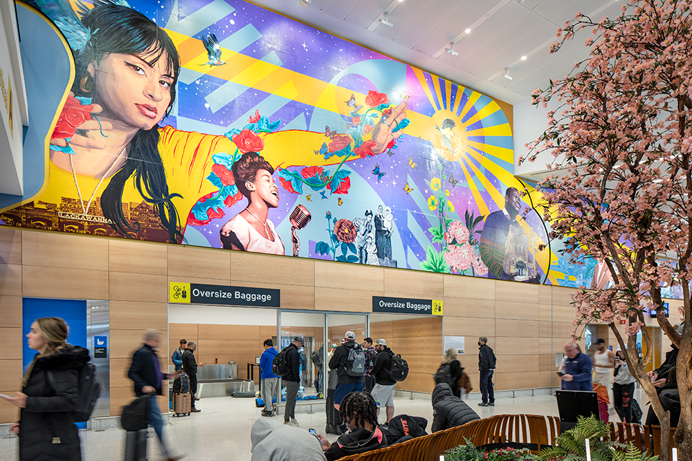 A brightly colored horizontal mural in an airport terminal featuring Newark Airport employees and notable historical icons in the New Jersey region, with a blue...